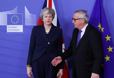 FILE PHOTO: European Commission President Jean-Claude Juncker shakes hands with British Prime Minister Theresa May at the European Commission headquarters in Brussels, Belgium February 7, 2019. REUTERS/Yves Herman