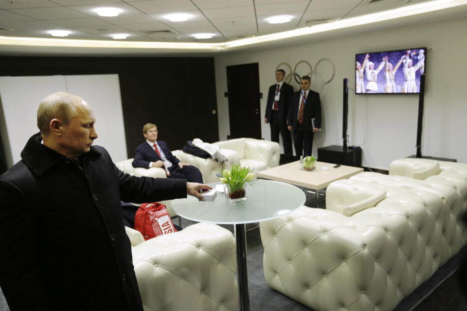 In this third in a sequence of four images, two seconds after the previous one, Russian President Vladimir Putin turns toward a TV screen in the presidential lounge while waiting to be introduced at the opening ceremony of the 2014 Winter Olympics on Friday, Feb. 7, 2014, in Sochi, Russia. Early in the ceremony, the image on the TV cut to performers after one of the five Olympic rings failed to open. (AP Photo/David Goldman, Pool)