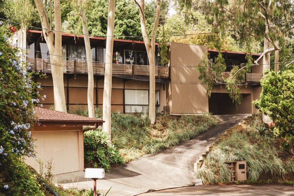 The 1960s home sits nestled on an elevated lot in Pasadena's popular San Rafael Hills neighborhood, encompassed by mature Eucalyptus trees and lush vegetation.