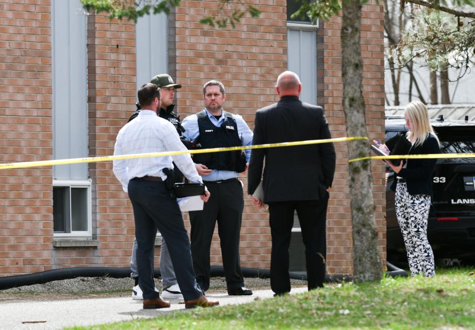 Members of the Lansing Police Dept., ATF, and Michigan State Police work at the scene of a shooting, Wednesday, April 10, 2024, where two officers and a susperct were shot Wednesday morning. All three people who were shot suffered non-life-threatening wounds, Police Chief Ellery Sosebee said at a press conference.