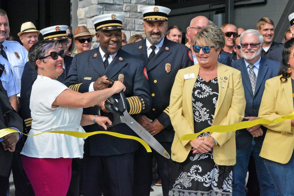 Columbia Mayor Barbara Buffaloe and Columbia Fire Chief Clayton Farr Jr. cut the ribbon for station 11 Tuesday surrouned by current and former fire department staff, Columbia Chamber of Commerce ambassadors and other city leadership.