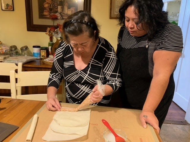 Beverly Lacsina, chef/owner of Walnut Street Kitchen in Montclair, and her mom prepare Filipino spring rolls