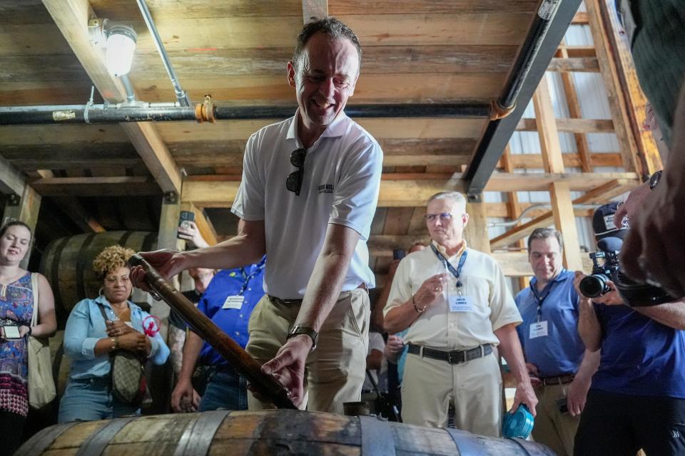 Conor O'Driscoll, Heaven Hill's Master Distiller uses a whiskey thief to remove small amounts of bourbon from barrels at the Cox Creek Barrel Preserve on Tuesday, June 18, 2024. The whiskey in the barrels will eventually be released as part of the new Heaven Hill Grain to Glass line.