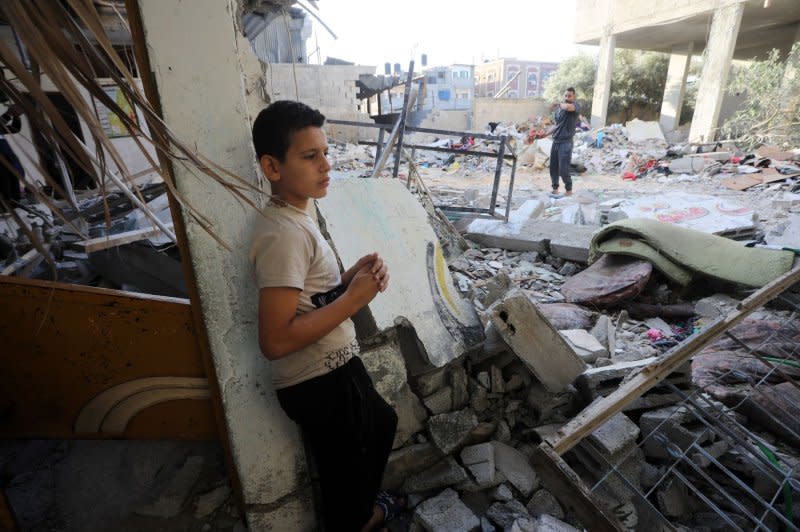 A Palestinians boy stand amid the rubble of a family house that was destroyed during Israeli air raid in Rafah in the southern Gaza Strip on Monday. Photo by Ismael Mohamad/UPI