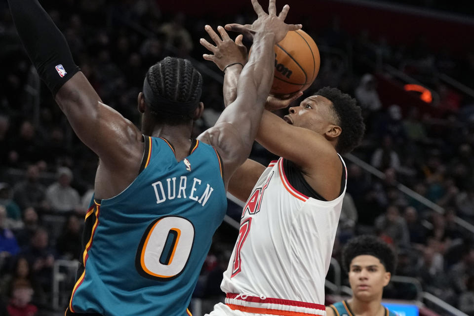 Miami Heat guard Kyle Lowry (7) attempts a shot as Detroit Pistons center Jalen Duren (0) defends during the second half of an NBA basketball game, Tuesday, April 4, 2023, in Detroit. (AP Photo/Carlos Osorio)