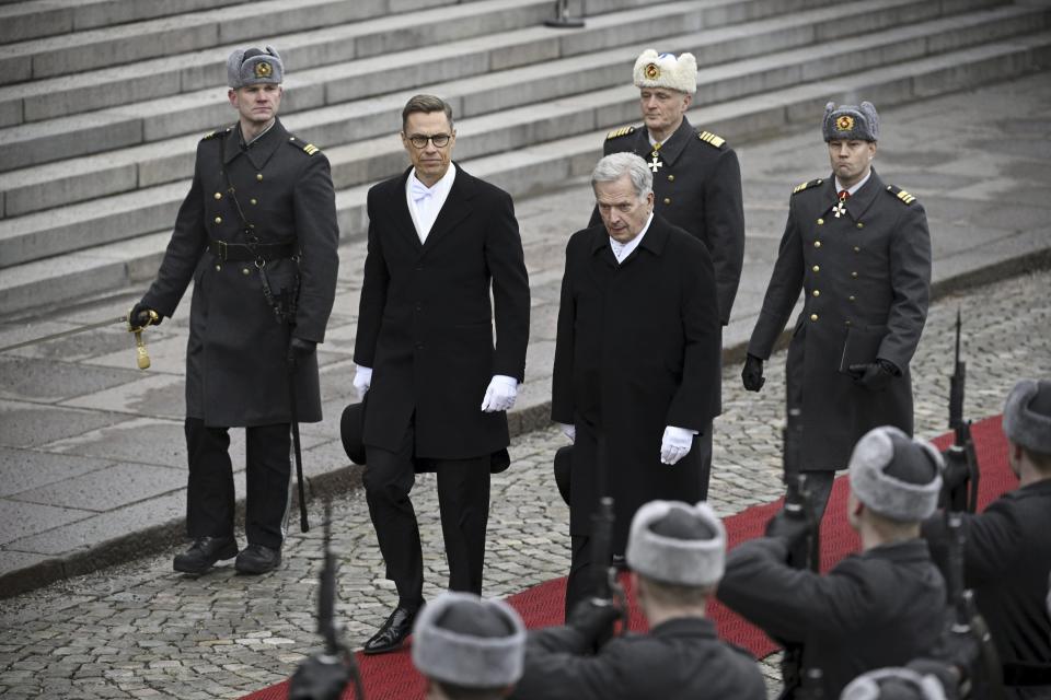 Incumbent President of the Republic of Finland Sauli Niinistö and President-elect Alexander Stubb, second left, inspect the Guard of Honour before attending Parliament's plenary session during the inauguration of the President of the Republic of Finland in Helsinki, Finland, Friday March 1, 2024. (Antti Aimo-Koivisto/Lehtikuva via AP)