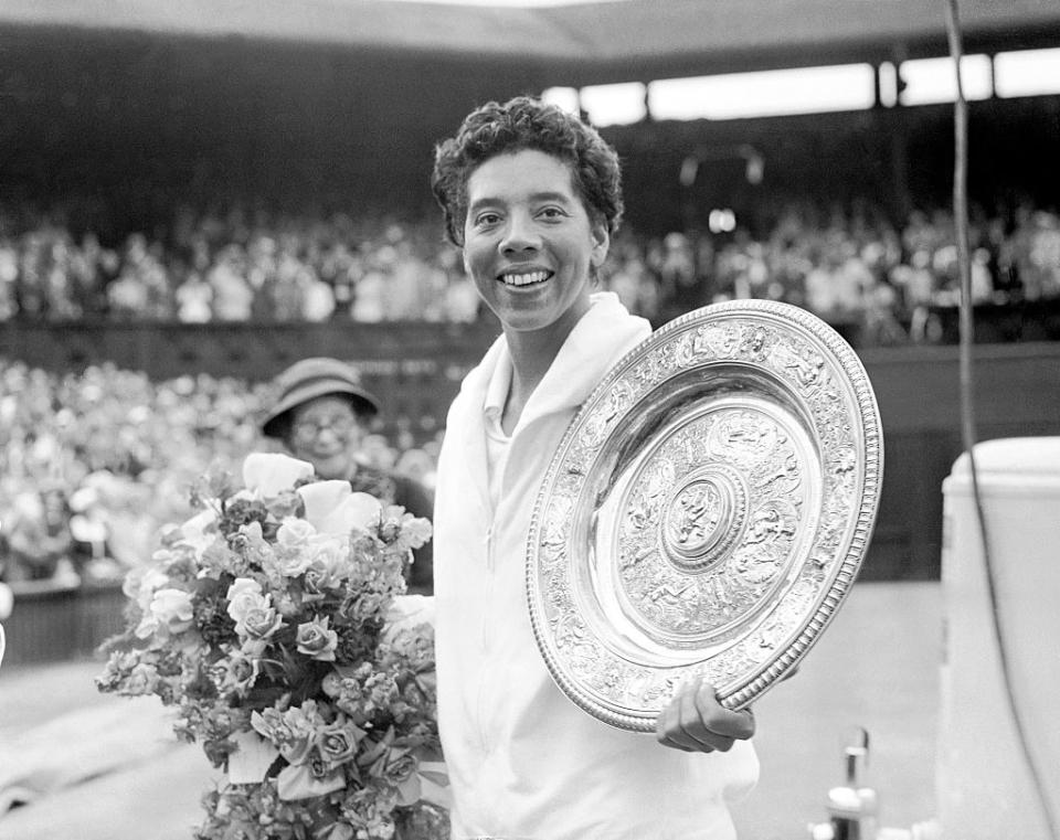 Althea Gibson with the Wimbledon trophy after her straight sets victory over Angela Mortimer. (Photo by Barratts/PA Images via Getty Images)