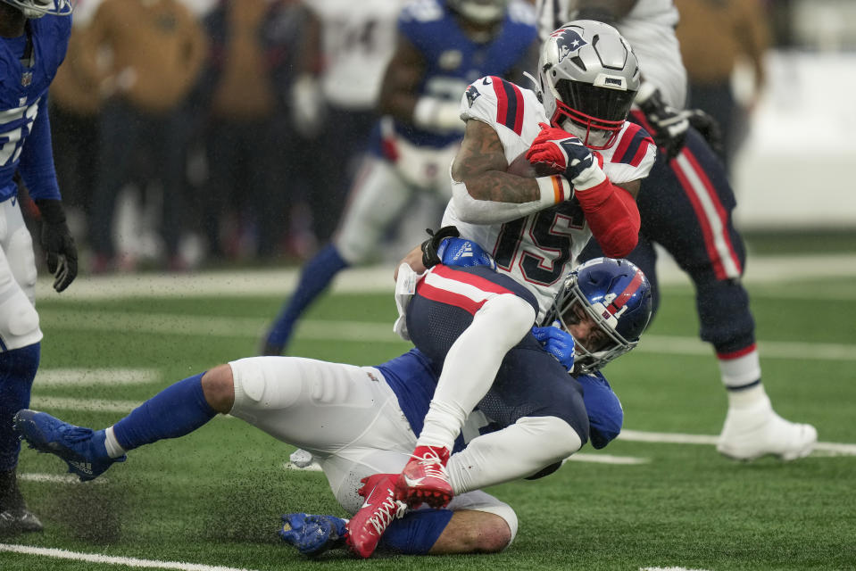 New York Giants linebacker Micah McFadden (41) tackles New England Patriots running back Ezekiel Elliott (15) during the third quarter of an NFL football game, Sunday, Nov. 26, 2023, in East Rutherford, N.J. (AP Photo/Seth Wenig)