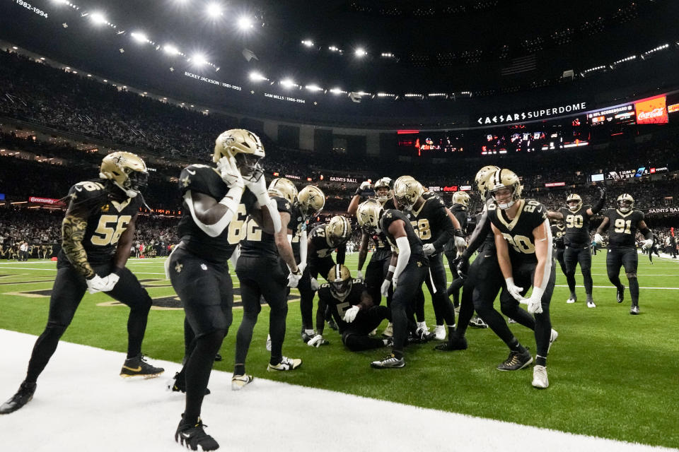 Members of the New Orleans Saints defense celebrate an interception against the Carolina Panthers during the first half of an NFL football game Sunday, Sept. 8, 2024, in New Orleans. (AP Photo/Gerald Herbert)