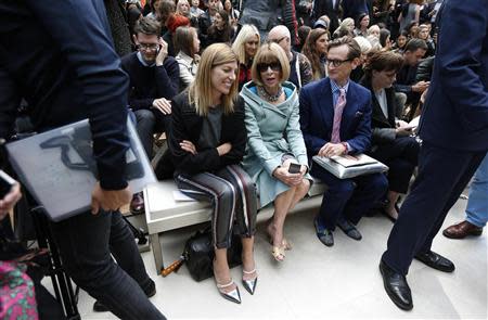 Vogue's fashion market/accessories director Virginia Smith (L), U.S. Vogue editor Anna Wintour (C) and European editor-at-large for Vogue Hamish Bowles sit on the front row before the Burberry Prorsum Spring/Summer 2014 collection during London Fashion Week September 16, 2013. REUTERS/Suzanne Plunkett