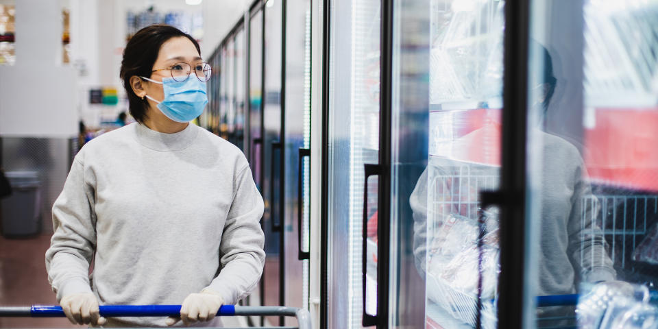 Asian female wearing a face mask shopping at the supermarket (Getty Images stock)