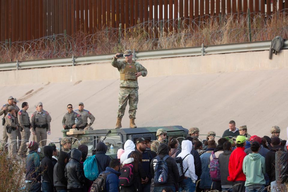 Migrants crossed the Rio Grande and approach the Texas National Guard to enquire when they will be allowed to be processed by Customs and Border Protection to seek asylum in El Paso, Texas on Dec. 20, 2022 