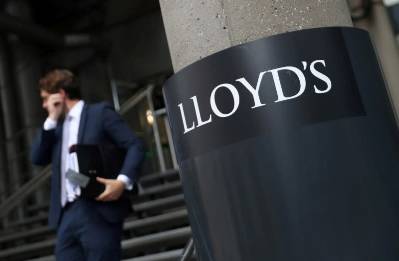 FILE PHOTO: A man walks out of Lloyds of London's headquarters in the City of London