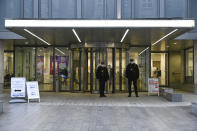 Police officers stand outside the main entrance of the St Bartholomew's Hospital where Britain's Prince Philip is being treated, in London, Thursday, March 4, 2021. Buckingham Palace said Philip, the 99-year-old husband of Queen Elizabeth II, was transferred from King Edward VII's Hospital to St Bartholomew's Hospital on Monday to undergo testing and observation for a pre-existing heart condition as he continues treatment for an unspecified infection.(AP Photo/Alberto Pezzali)