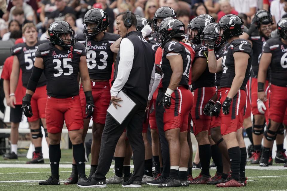 Cincinnati coach Luke Fickell speaks with his team on the sideline during a game against Miami (Ohio)