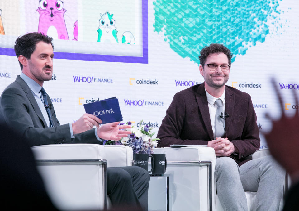 CoinDesk research director Nolan Bauerle (R) speaks to Yahoo Finance’s Dan Roberts at the Yahoo Finance All Markets Summit: Crypto on Feb. 7, 2018. The homepage of the Ethereum game CryptoKitties shows on screen. (Gino DePinto/Oath)