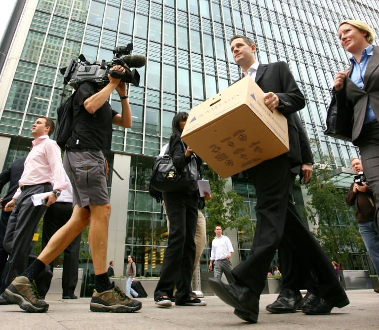 Stunned traders streaming out of the building carrying boxes of their belongings became a symbol of the crisis