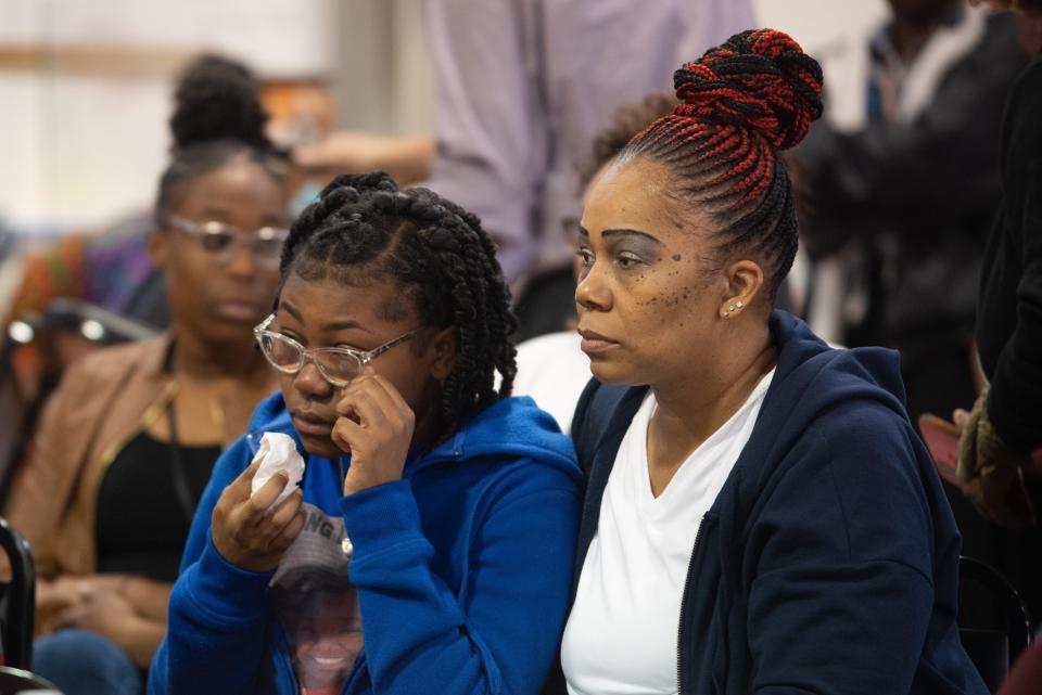 Lah’Nayah Duncan Lowry, daughter of Taylor Lowry, is comforted by Yvonne Duncan as she wipes tears from her eyes during a news conference Sunday afternoon calling for Topeka police to release the body cam footage of her father's shooting.