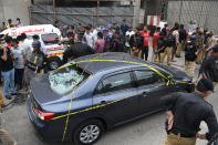 KARACHI, PAKISTAN - JUNE 29: Police officers inspect the site after gunmen attacked the Pakistani stock exchange building in Karachi, Pakistan on June 29, 2020. At least nine people were killed. The dead include four attackers, four Pakistan Stock Exchange security guards and a policeman, Muqaddas Haider, a city police chief, told reporters. At least seven people are also injured. (Photo by Sabir Mazhar/Anadolu Agency via Getty Images)