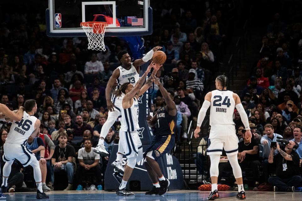 The Memphis Grizzlies forward Jaren Jackson Jr. (13) and forward Brandon Clarke (15) defend against the New Orleans Pelicans forward Zion Williamson (1) during a game on Dec. 31, 2022 at the Fedex Forum in Memphis.