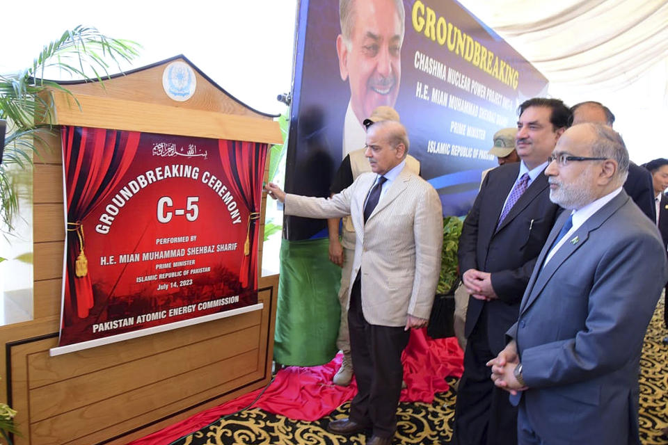 In this photo released by Press Information Department, Pakistan's Prime Minister Shehbaz Sharif, center, unveils plaque during the groundbreaking ceremony of 5th Unit of Chashma Nuclear Power Plant (Chashma-5) in Chashma, Mianwali, Pakistan, Friday, July 14, 2023. Sharif launched the construction of a 1,200-megawatt Chinese-designed nuclear energy project, which will be built at a cost of $3.5 billion as part of the government efforts to generate more clean energy in the Islamic nation. (Press Information Department via AP)