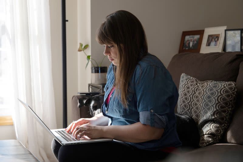 Katy McAvoy works on her food blog in her living room in Grand Rapids, Michigan, U.S., March 2, 2021. REUTERS/Emily Elconin