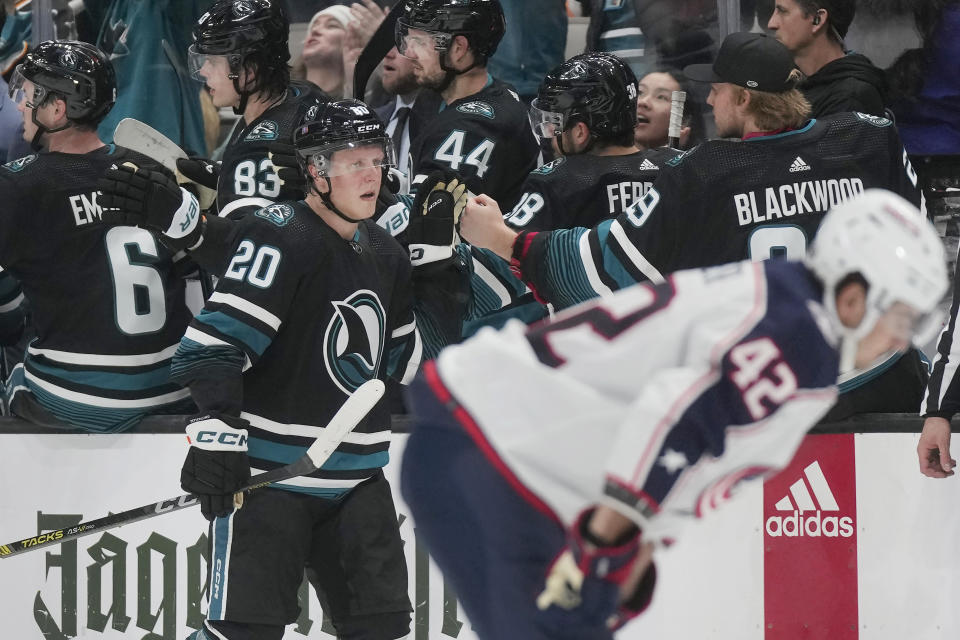 San Jose Sharks left wing Fabian Zetterlund (20) is congratulated by teammates after scoring against the Columbus Blue Jackets during the second period of an NHL hockey game in San Jose, Calif., Saturday, Feb. 17, 2024. (AP Photo/Jeff Chiu)
