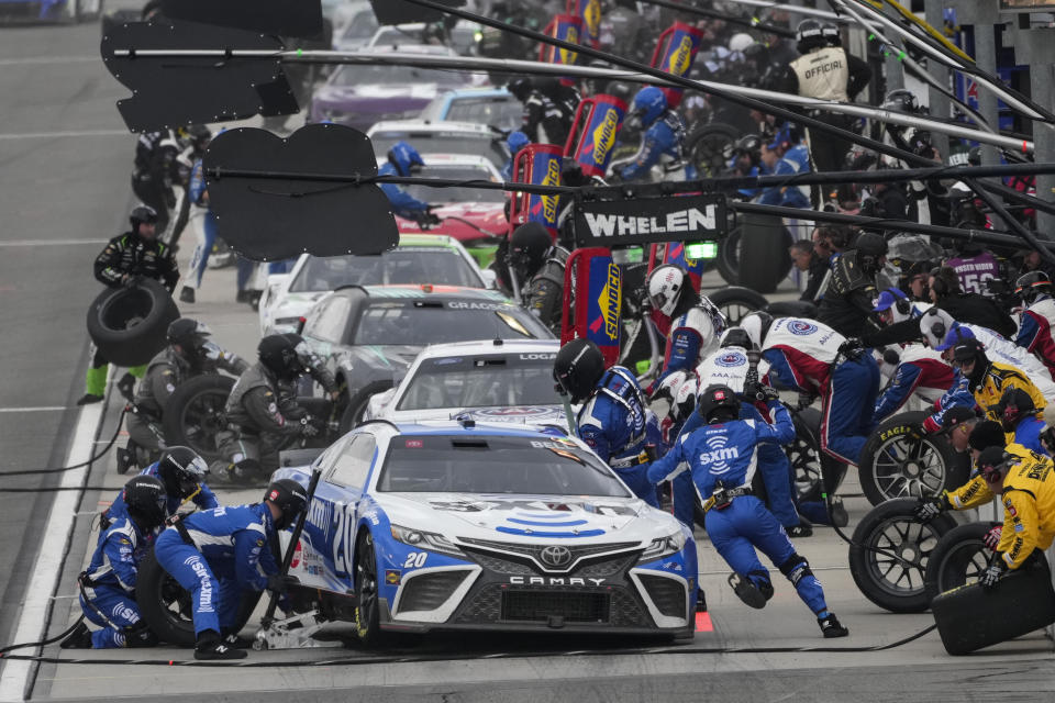 Christopher Bell (20) makes a pit stop during a NASCAR Cup Series auto race at Auto Club Speedway in Fontana, Calif., Sunday, Feb. 26, 2023. (AP Photo/Jae C. Hong)