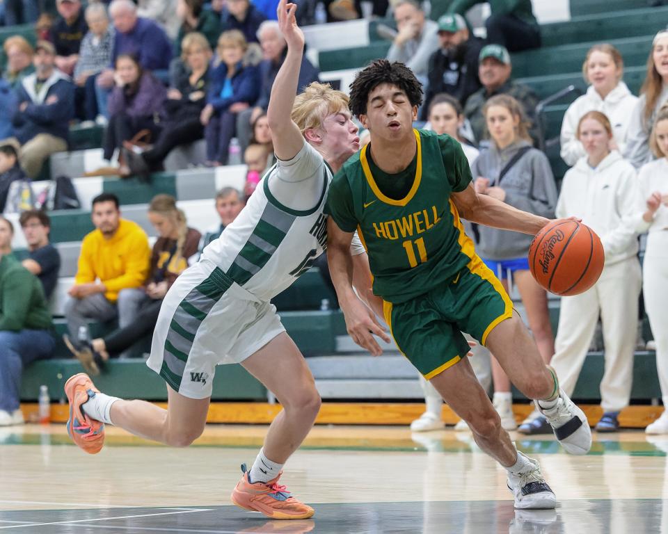 Howell's Jalen Hicks (11) scored 26 points in his varsity basketball debut at Williamston on Dec. 6, 2022.