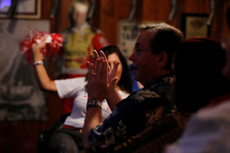 A supporter of President Donald Trump applauds while listening to him speak to congress during a Pinellas County Republican Party watch party in Clearwater, Florida, U.S. February 28, 2017. REUTERS/Scott Audette