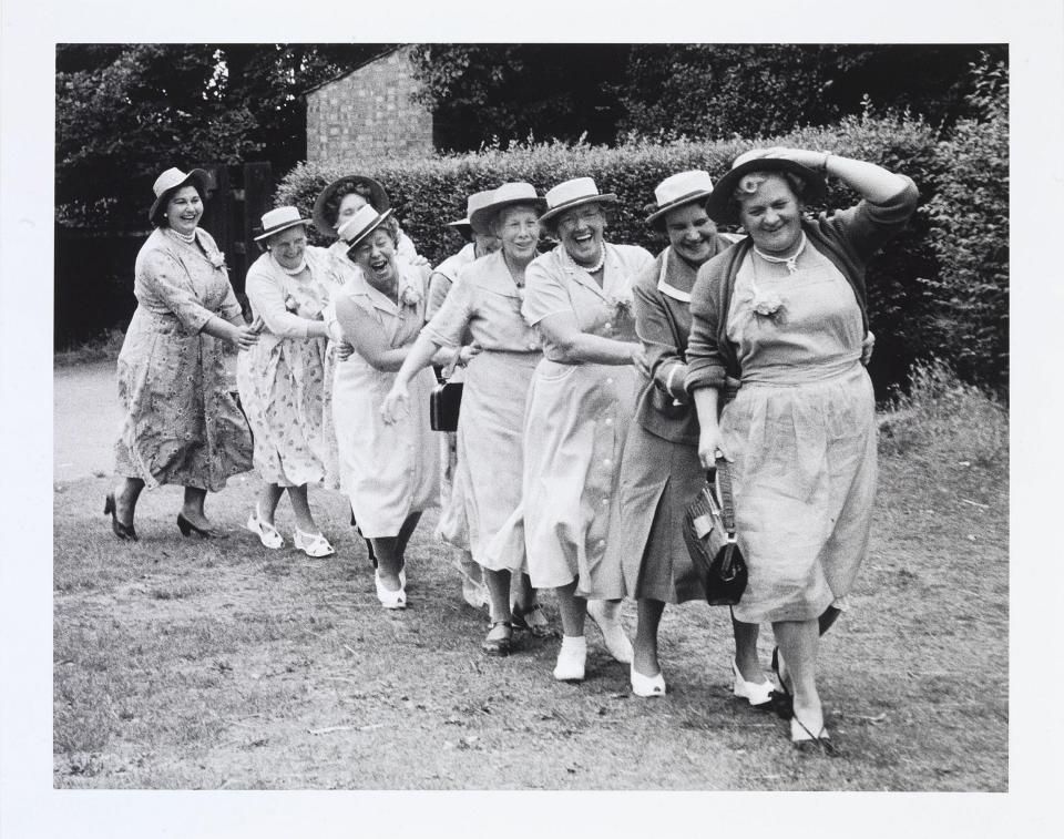 Women from Clapham on a pub outing, dancing in a conga line, 1956 - Grace Robertson/Bonhams/PA Wire
