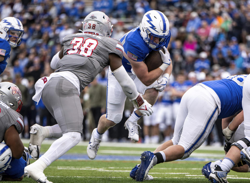 Air Force running back Dylan Carson (20) carries against UNLV during the first half of an NCAA college football game Saturday, Nov. 18, 2023, at Air Force Academy, Colo. (Parker Seibold/The Gazette via AP)