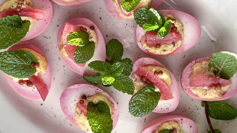 pink easter deviled eggs on platter