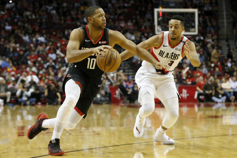 HOUSTON, TX - DECEMBER 11:  Eric Gordon #10 of the Houston Rockets drives to the basket defended by CJ McCollum #3 of the Portland Trail Blazers in the second half at Toyota Center on December 11, 2018 in Houston, Texas.  NOTE TO USER: User expressly acknowledges and agrees that, by downloading and or using this photograph, User is consenting to the terms and conditions of the Getty Images License Agreement.  (Photo by Tim Warner/Getty Images)