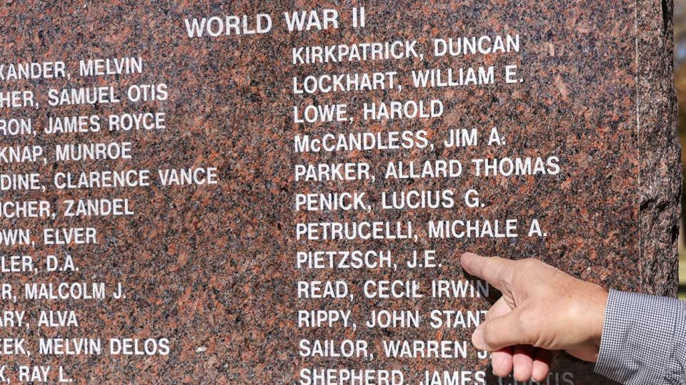 J. Pat Richmond of Amarillo points out the name of his cousin, Jay E. Pietzsch, enscribed on the WT Veterans Memorial.