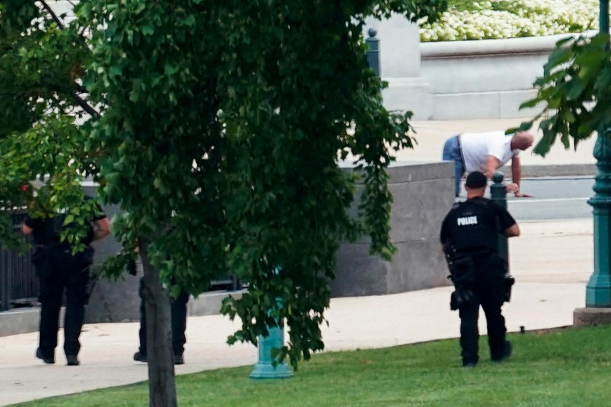 A person is apprehended after being in a pickup truck parked on the sidewalk in front of the Library of Congress' Thomas Jefferson Building. The man was identified as Floyd Ray Roseberry, 49, of Grover, North Carolina, according to two people briefed on the matter. (AP Photo/Alex Brandon) (AP)