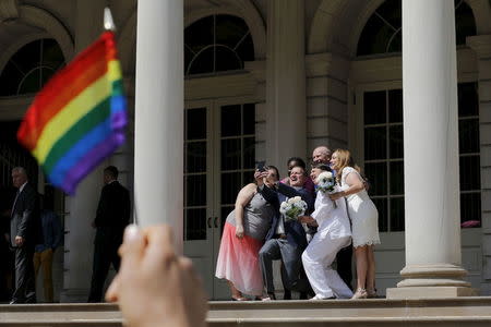 Terrence McNally and Thomas Kirdahy (C), Sarah Joseph (front 2nd R) and Katrina Council (R), Denise Niewinski and Cindy Jackson (L) pose for a selfie after their marriage on the steps of City Hall, in New York June 26, 2015. REUTERS/Eduardo Munoz