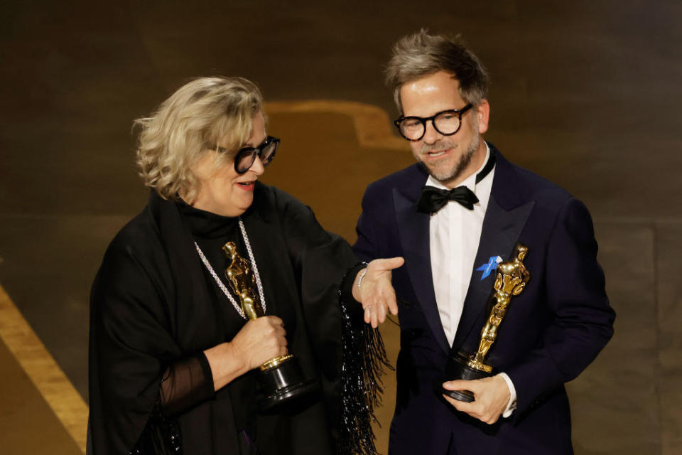 Ernestine Hipper and Christian M. Goldbeck accept the award for Best Production Design for "All Quiet on the Western Front" onstage