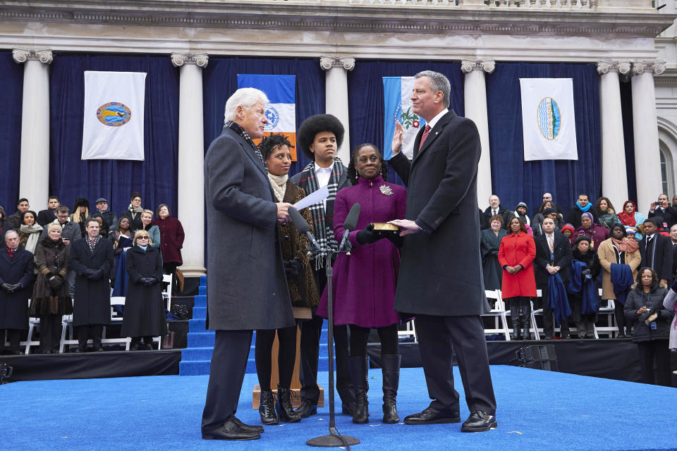 New York City Mayor Bill de Blasio, right, takes the oath of office in 2014. Progressives rejoiced at de Blasio's election, but now say that his tenure has undermined the left. (Photo: James Keivom/Getty Images)