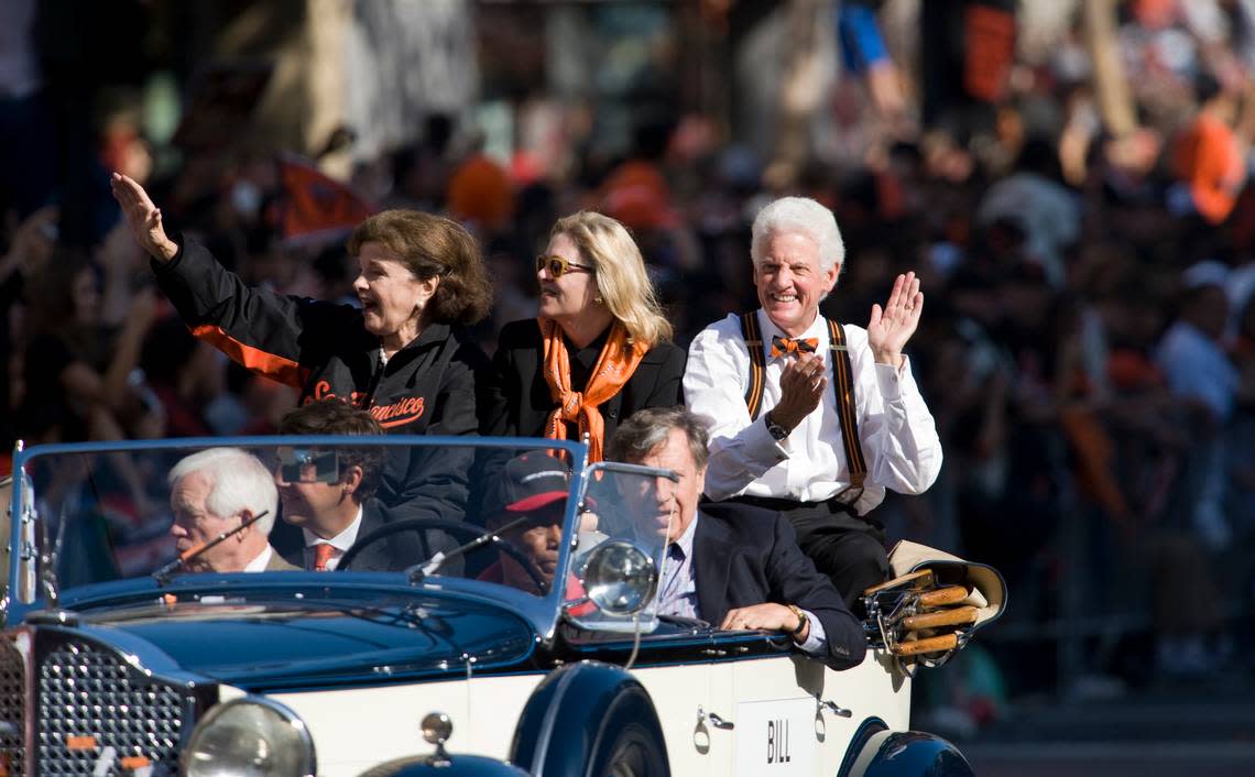 Sen. Diane Feinstein, left, and Giants owner Bill Neukom ride in a vintage car as the the San Francisco Giants celebrate their World Series win with a parade down Market Street in San Francisco on Nov. 3, 2010.