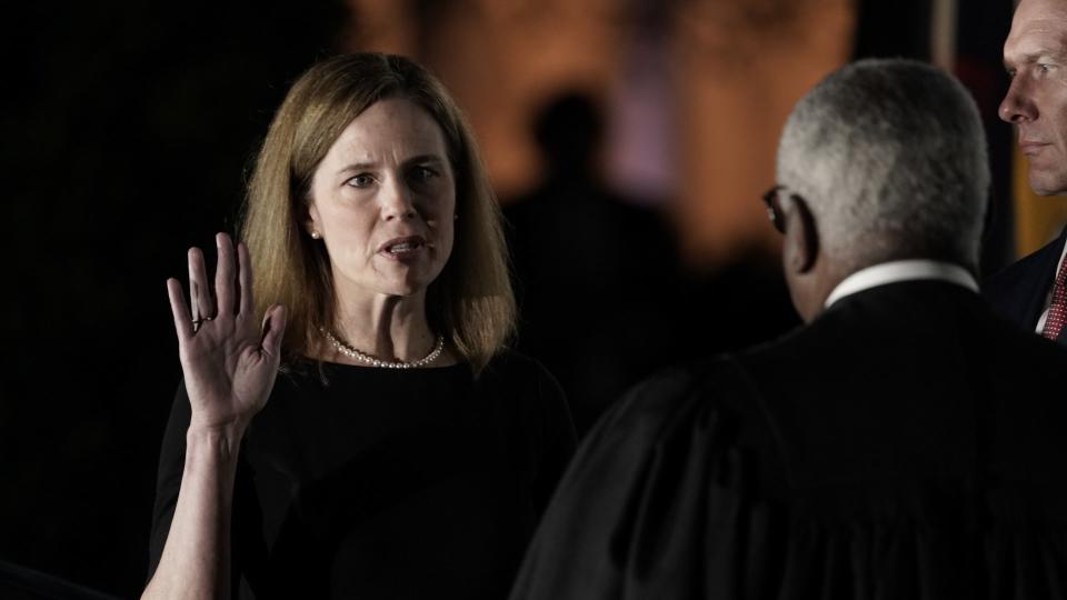 Mandatory Credit: Photo by Ken Cedeno/POOL/EPA-EFE/Shutterstock (10976023f)Associate Justice of the Supreme Court Clarence Thomas (R) administers the oath of office to Judge Amy Coney Barrett (L) to be Associate Justice of the Supreme Court on the South Lawn of the White House in Washington, DC, USA, 26 October 2020.