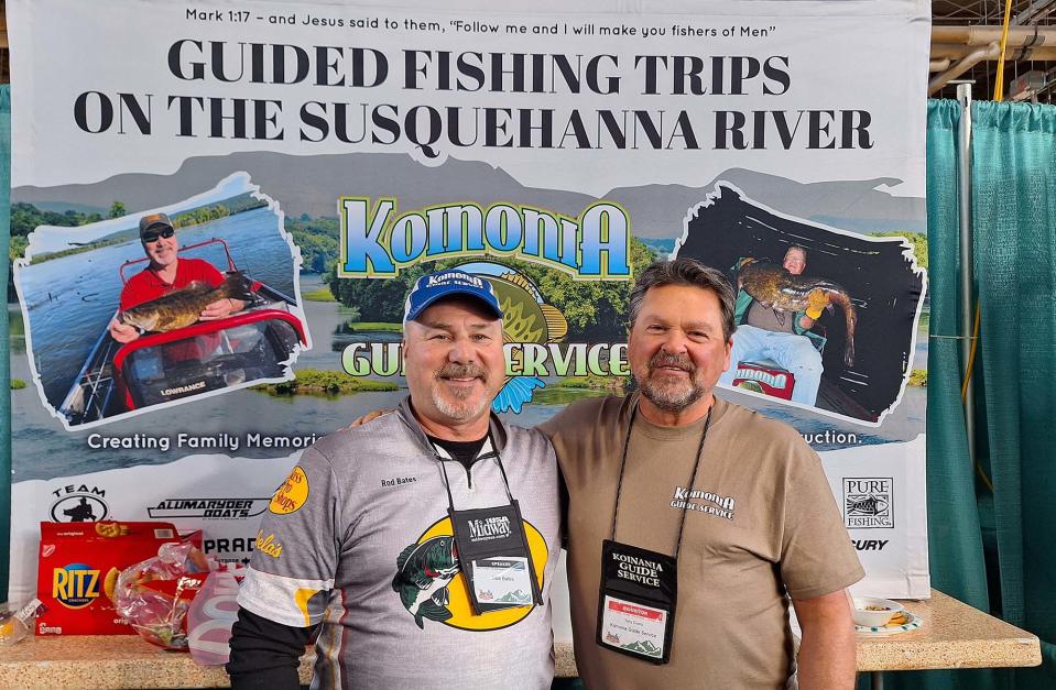 Rod Bates, left, and Tony Cicero of Koinonia Guide Service talk about the quality of fish that can be found on the Susquehanna River while attending the Great American Outdoor Show in Harrisburg.