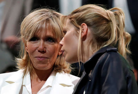 Brigitte Trogneux (L), wife of Emmanuel Macron, head of the political movement En Marche !, or Onwards !, and candidate for the 2017 presidential election, and her daughter Tiphaine attend a political rally in Paris, France, April 17, 2017. REUTERS/Christian Hartmann