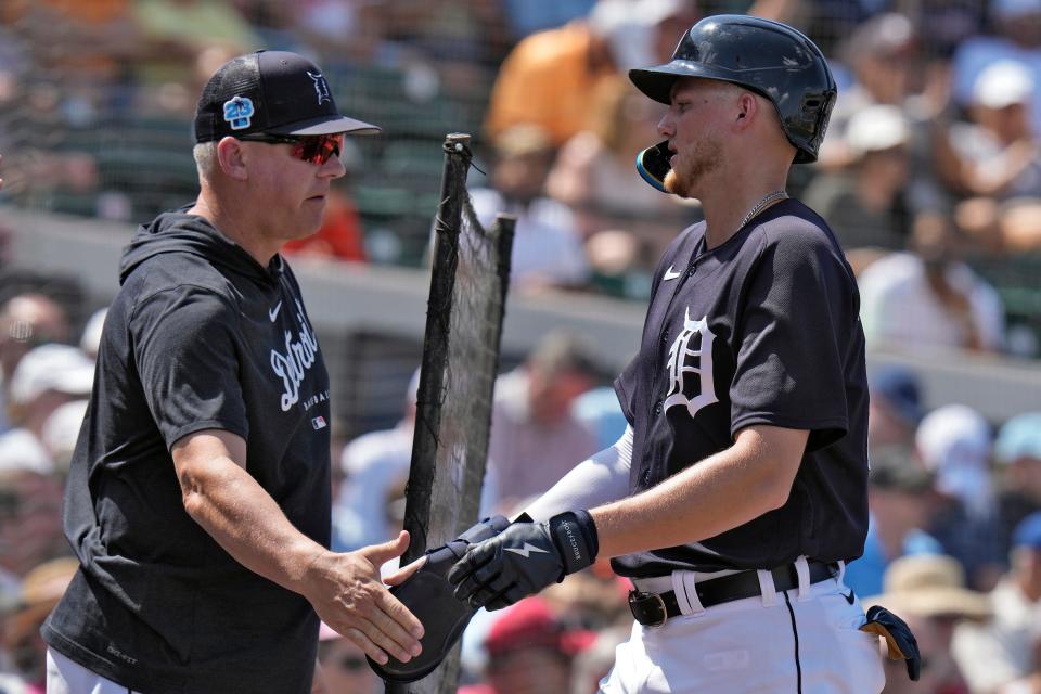 Tigers center fielder Parker Meadows, right, shakes hands with manager A.J. Hinch after scoring on a single by Andre Lipcius during the second inning of the Tigers' 18-5 spring training game loss on Saturday, March 4, 2023, in Lakeland, Florida.