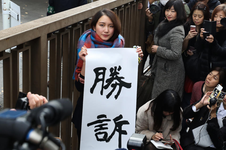 TOKYO, JAPAN - DECEMBER 18: Shiori Ito holds up sign showing victory in front of the Tokyo District Court on December 18, 2019 in Tokyo, Japan. A Tokyo court awarded 3.3 million yen (US$30,000) in damages to journalist Shiori Ito, who accused a former TV reporter of rape in one of Japanese #MeToo movement cases. (Photo by Takashi Aoyama/Getty Images)