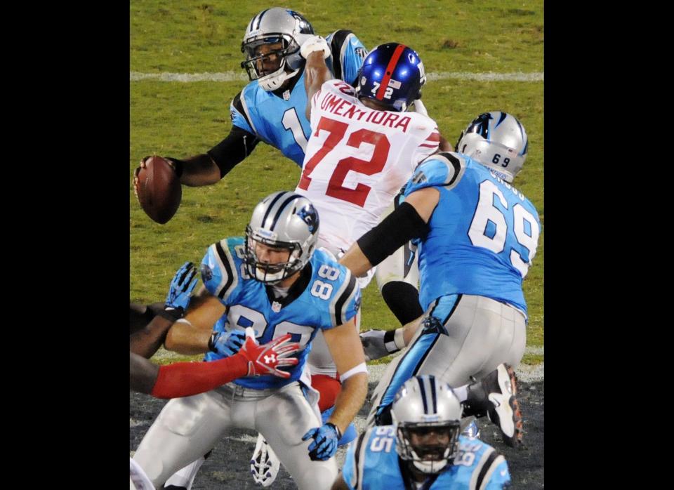 Carolina Panthers quarterback Cam Newton (1) is sacked by New York Giants defensive end Osi Umenyiora (72) during the second quarter of an NFL football game in Charlotte, N.C., Thursday, Sept. 20, 2012. 