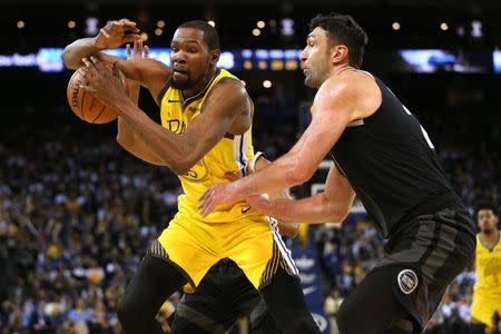 Mar 24, 2019; Oakland, CA, USA; Golden State Warriors forward Kevin Durant (35) has the ball knocked away by Detroit Pistons center Zaza Pachulia (27) in the fourth quarter at Oracle Arena. Mandatory Credit: Cary Edmondson-USA TODAY Sports