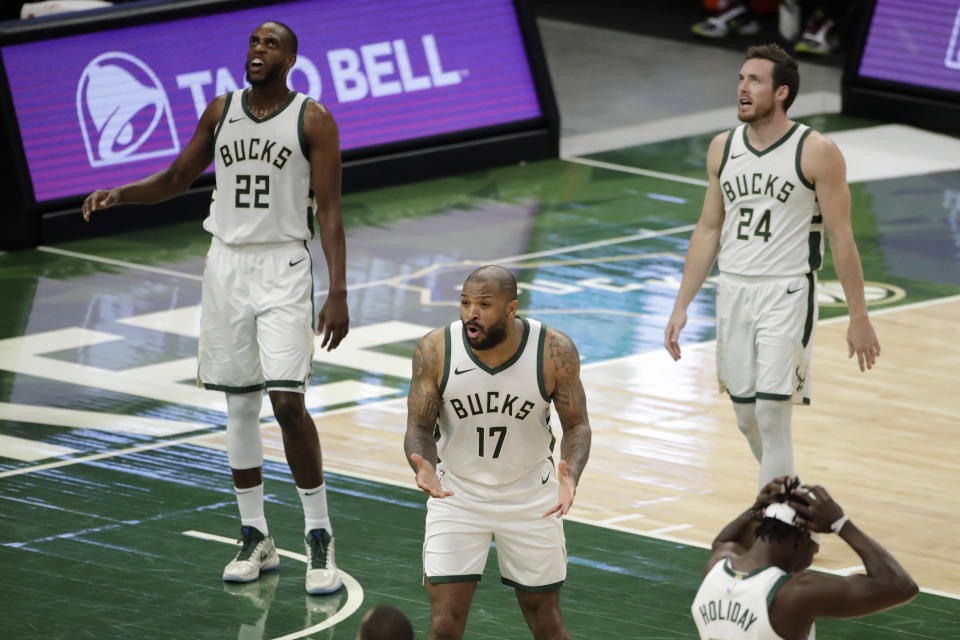 Milwaukee Bucks' P.J. Tucker (17) and teammates reacts to a foul call during the first half of the team's NBA basketball game against the Philadelphia 76ers on Thursday, April 22, 2021, in Milwaukee. (AP Photo/Aaron Gash)