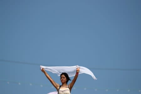 A woman holds up a fabric during a religious retreat lead by T.B. Joshua, a Nigerian evangelical preacher on Mount Precipice, Nazareth