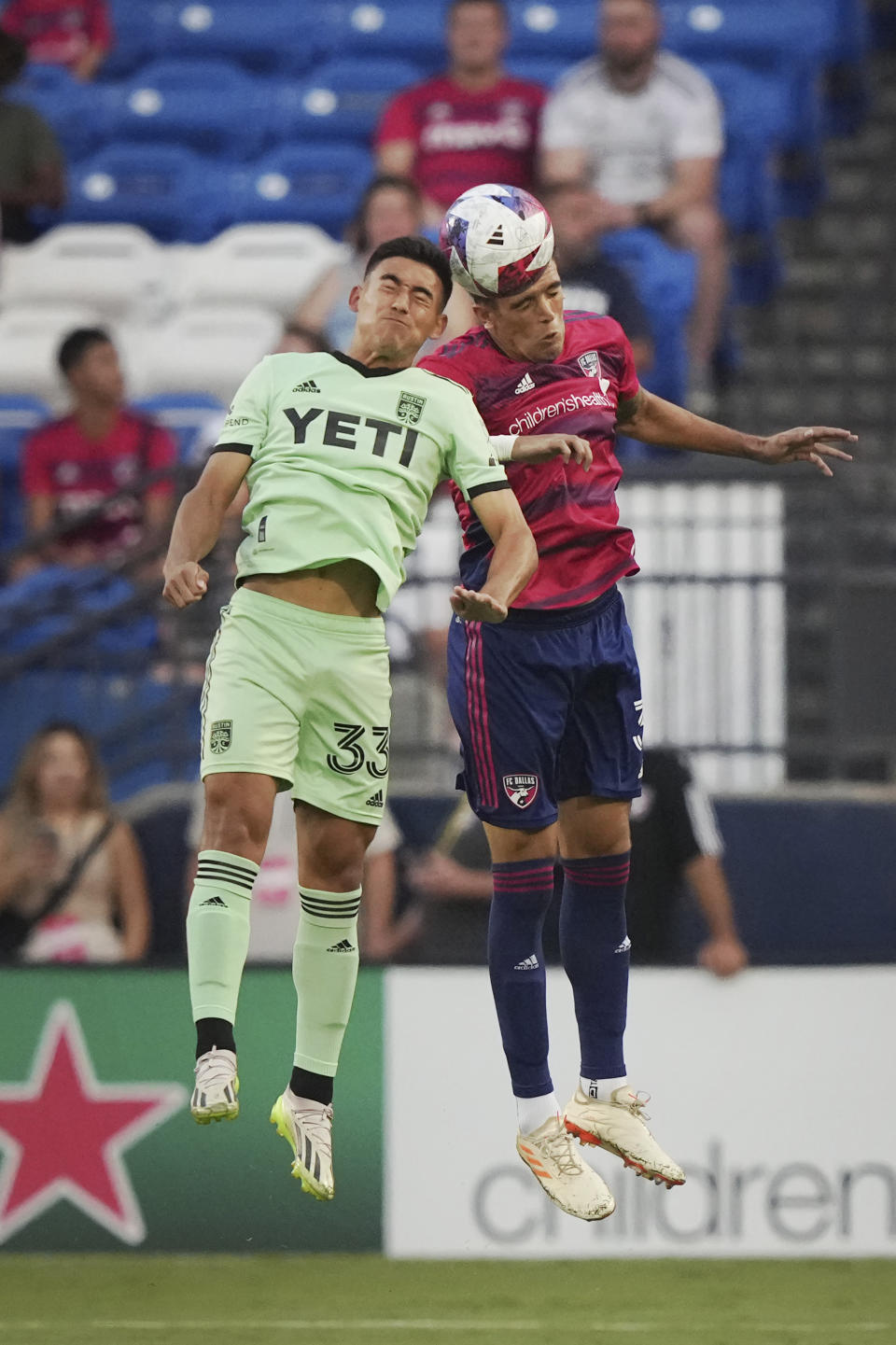 Austin FC midfielder Owen Wolff (33) and FC Dallas defender José Antonio Martínez (3) jump for a head ball during the first half of an MLS soccer match Saturday, Aug. 26, 2023, in Frisco, Texas. (AP Photo/LM Otero)